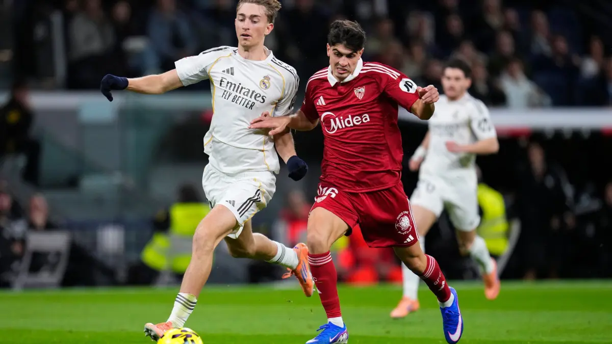 Real Madrid - FC Sevilla: 20.12.2025, Spanien, Madrid: Fußball, Männer, Primera División, Real Madrid - FC Sevilla: Sevillas Juanlu Sanchez (r) kämpft mit Real Madrids Dean Huijsen um den Ball. Foto: Manu Fernandez/AP/dpa +++ dpa-Bildfunk +++