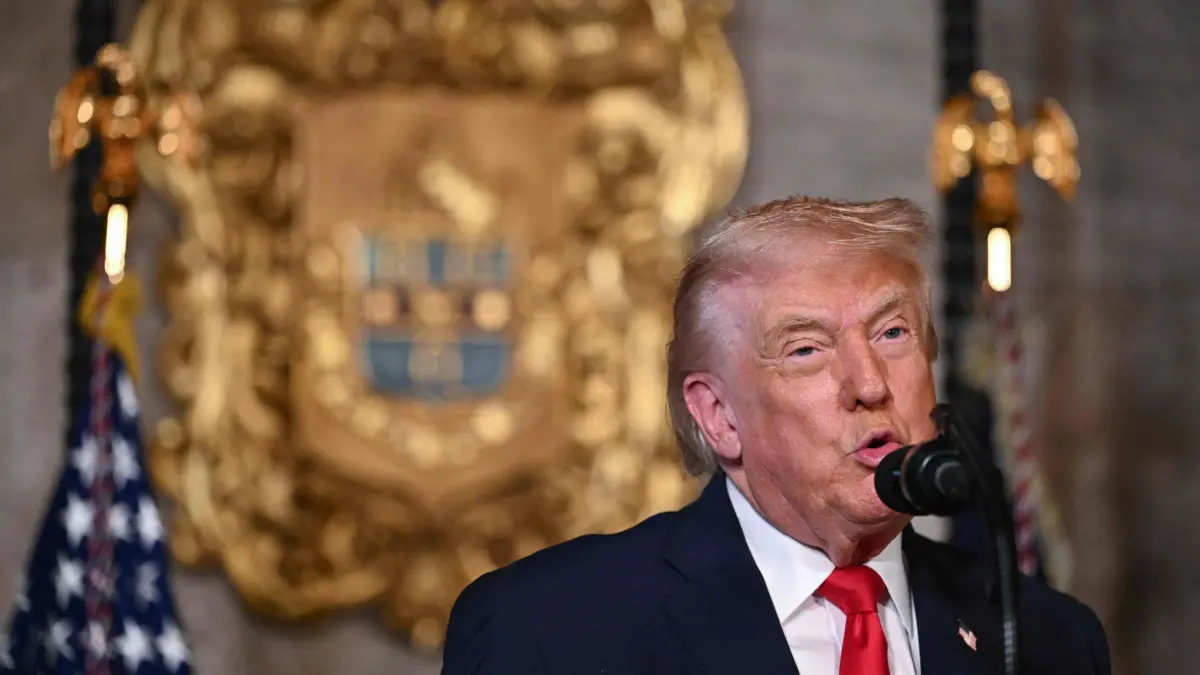 US President Donald Trump makes an announcement with Hegseth and Phelan: US President Donald Trump announces the US Navy’s new Golden Fleet initiative, unveiling a new class of frigates, at Mar-a-Lago in Palm Beach, Florida, on December 22, 2025. (Photo by ANDREW CABALLERO-REYNOLDS / AFP)