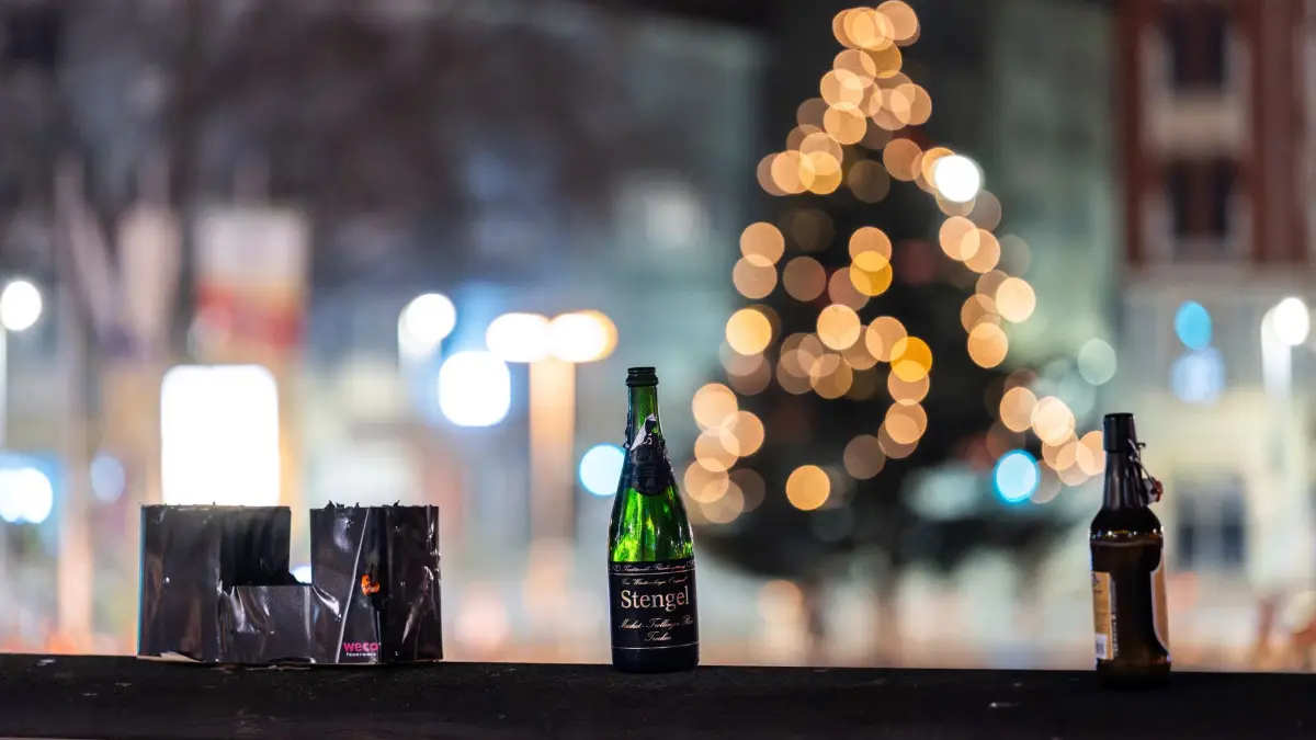 Silvester - Stuttgart: 01.01.2026, Baden-Württemberg, Stuttgart: Abgebrannte Feuerwerksbatterien (l-r), eine Sektflasche und eine Bierflasche stehen in der Silvesternacht auf dem Marienplatz. Foto: Silas Stein/dpa +++ dpa-Bildfunk +++