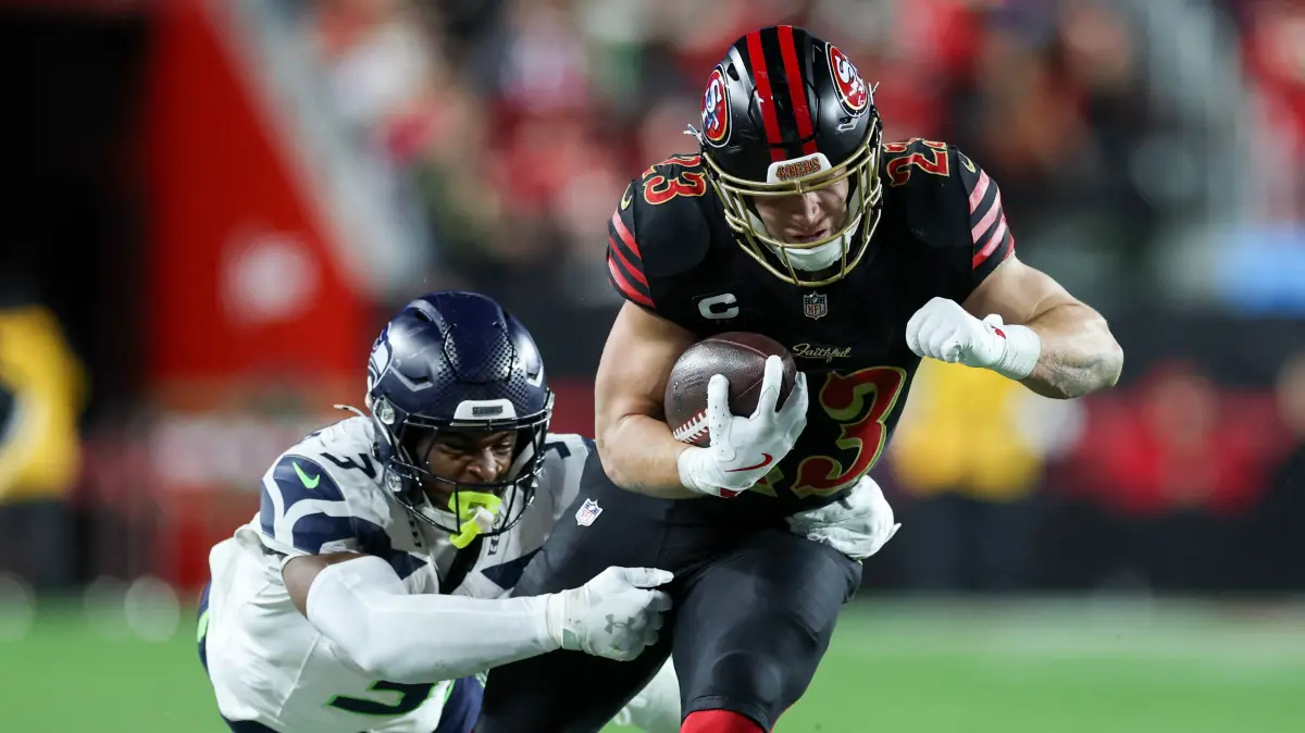 Seattle Seahawks v San Francisco 49ers - NFL 2025: SANTA CLARA, CALIFORNIA - JANUARY 03: Christian McCaffrey #23 of the San Francisco 49ers carries the ball against Nick Emmanwori #3 of the Seattle Seahawks during the second quarter of a game at Levi's Stadium on January 03, 2026 in Santa Clara, California. Ezra Shaw/Getty Images/AFP (Photo by EZRA SHAW / GETTY IMAGES NORTH AMERICA / Getty Images via AFP)