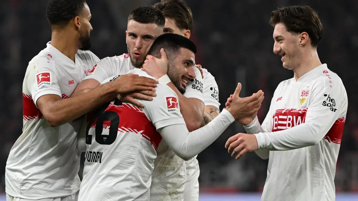 Stuttgart's German forward #26 Deniz Undav celebrates with his tam mates after scoring his team's second goal 2:1 during the German first division Bundesliga football match between VfB Stuttgart and Eintracht Frankfurt in Stuttgart, southern Germany, on January 13, 2026. (Photo by THOMAS KIENZLE / AFP) / DFL REGULATIONS PROHIBIT ANY USE OF PHOTOGRAPHS AS IMAGE SEQUENCES AND/OR QUASI-VIDEO