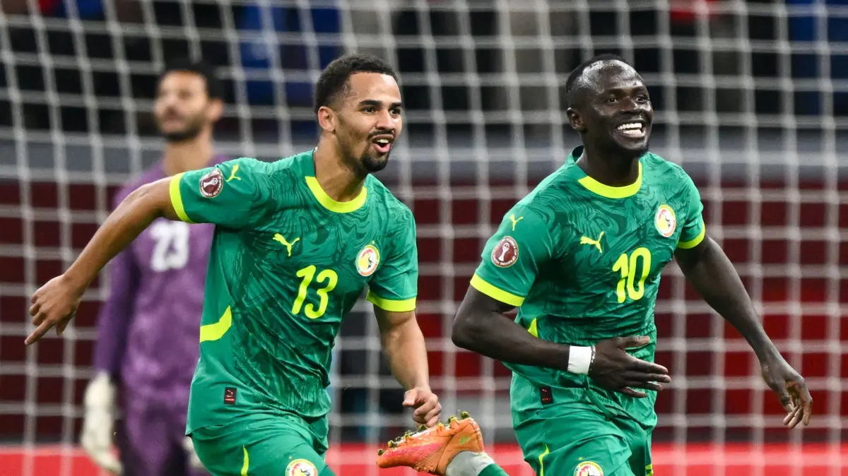 Senegal's forward #10 Sadio Mane celebrates his goal with Senegal's forward #13 Iliman Ndiaye during the Africa Cup of Nations (CAN) semi-final football match between Senegal and Egypt at the Grand stadium in Tangiers on January 14, 2026. (Photo by SEBASTIEN BOZON / AFP)