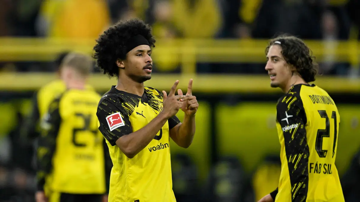 Dortmund's German forward #27 Karim Adeyemi (L) celebrates after scoring the 2-0 goal during the German first division Bundesliga football match between BVB Borussia Dortmund and FC St Pauli in Dortmund, western Germany, on January 17, 2026. (Photo by INA FASSBENDER / AFP) / DFL REGULATIONS PROHIBIT ANY USE OF PHOTOGRAPHS AS IMAGE SEQUENCES AND/OR QUASI-VIDEO