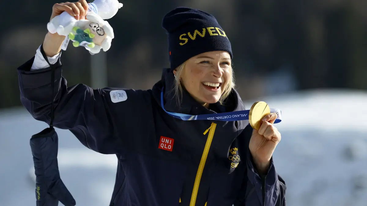 776396179: Gold medallist Sweden's Frida Karlsson celebrates on the podium for the women's cross-country skiing 10km interval start free event of the Milano Cortina 2026 Winter Olympic Games at Tesero Cross-Country Skiing Stadium in Lago di Tesero (Val di Fiemme), on February 12, 2026. (Photo by Anne-Christine POUJOULAT / AFP)