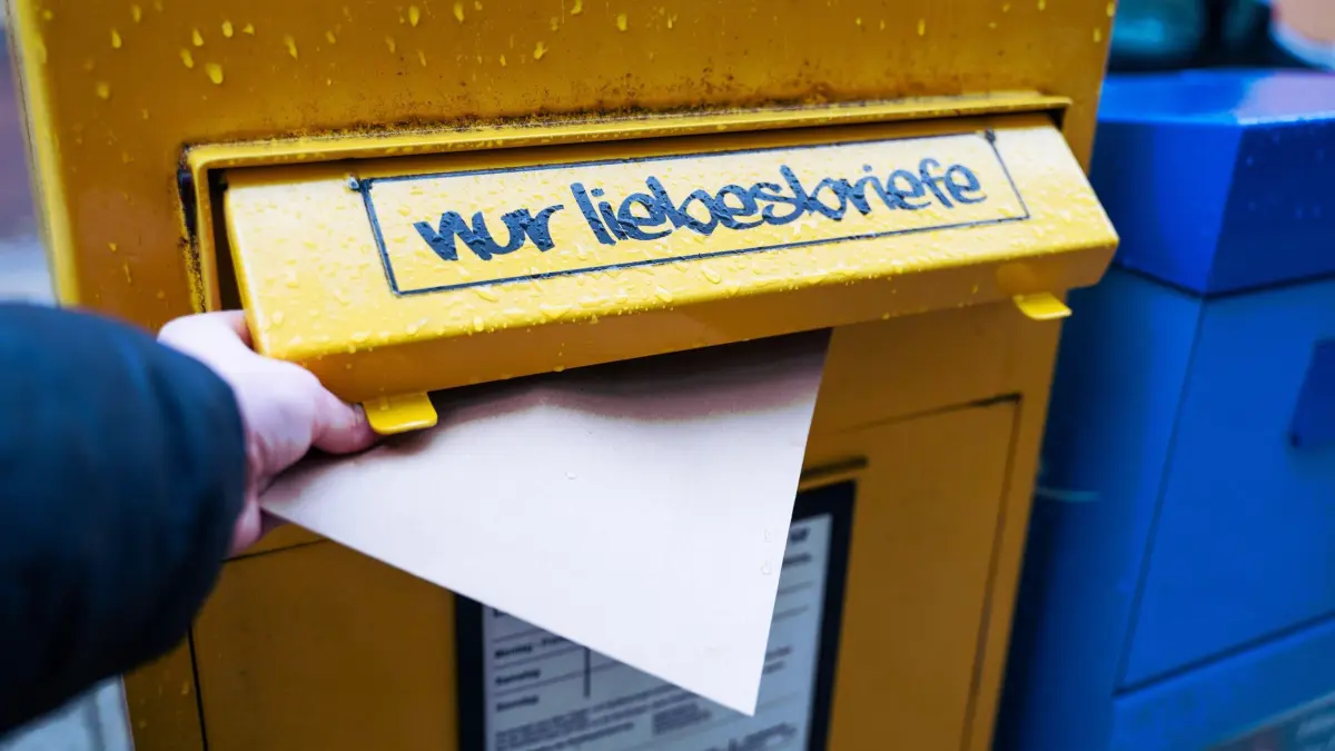 Briefkasten: ILLUSTRATION - 13.11.2024, Niedersachsen, Hannover: Eine Hand steckt einen Brief in einen gelben Briefkasten mit der humorvollen Aufschrift «nur Liebesbriefe». (zu dpa: «Valentinstag mal anders – Tipps für Paare und Singles») Foto: Alicia Windzio/dpa +++ dpa-Bildfunk +++