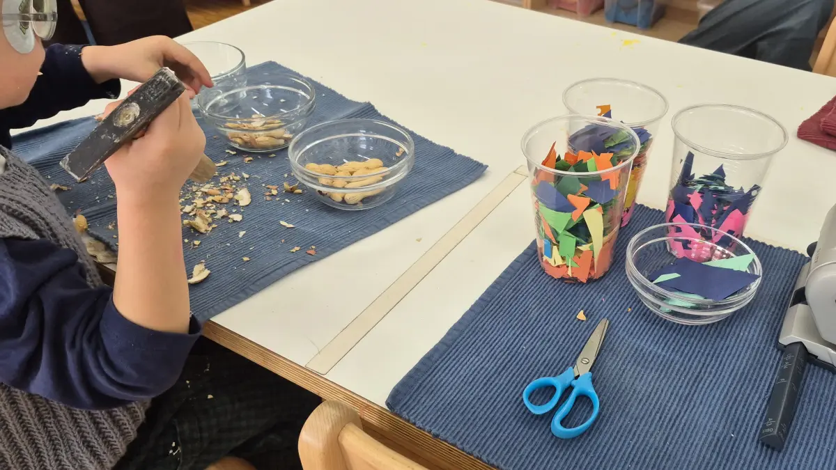 Montessori-Kindergarten in St. Johann: Einfach mal ausprobieren lautet hier die Devise. Warum sollten sich Erdnüsse also nicht auch mit einem kleinen Hammer öffnen lassen.