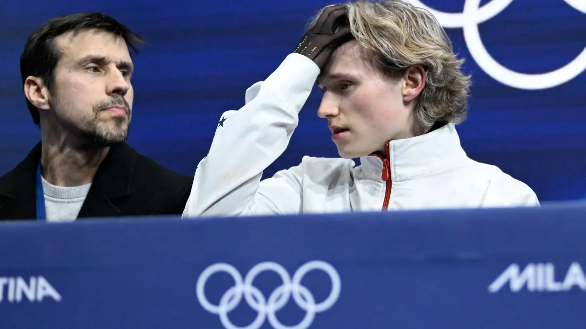 776395605: USA's Ilia Malinin (R) reacts in the kiss and cry area after competing in the figure skating men's singles free skating final during the Milano Cortina 2026 Winter Olympic Games at Milano Ice Skating Arena in Milan on February 13, 2026. (Photo by WANG Zhao / AFP)
