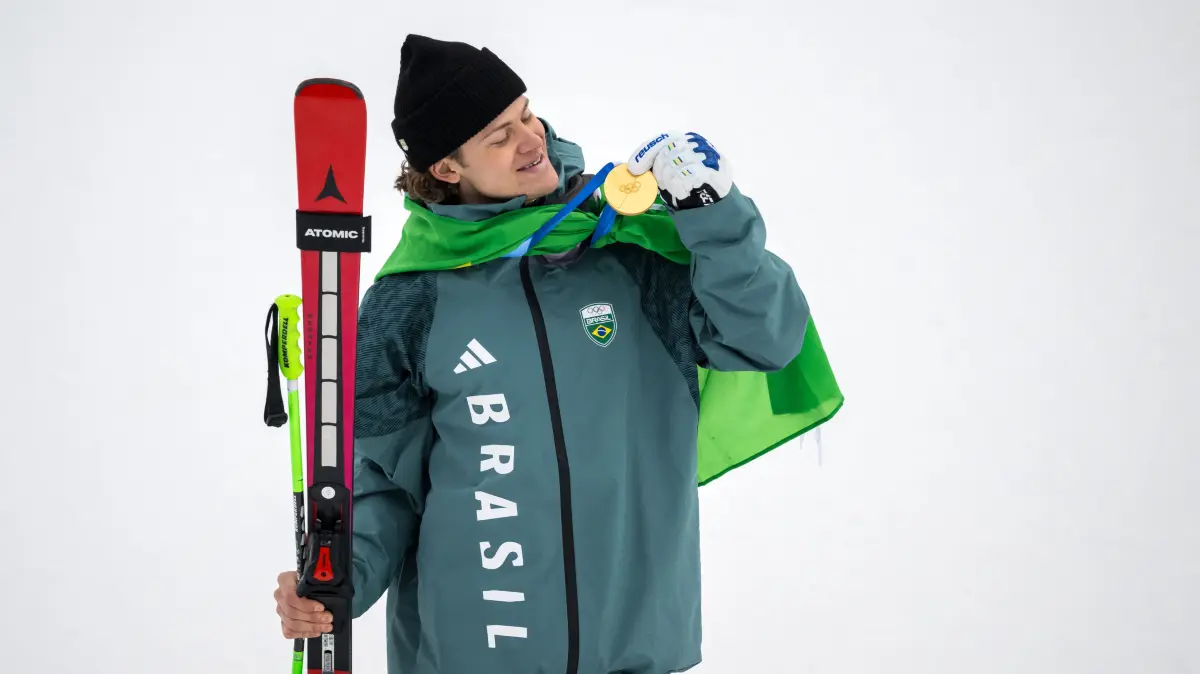 776394099: Brazil's gold medalist Lucas Pinheiro Braathen looks his medal on the podium of the men's giant slalom alpine skiing event during the Milano Cortina 2026 Winter Olympic Games at the Stelvio Ski Centre in Bormio (Valtellina) on February 14, 2026. (Photo by Fabrice COFFRINI / AFP)