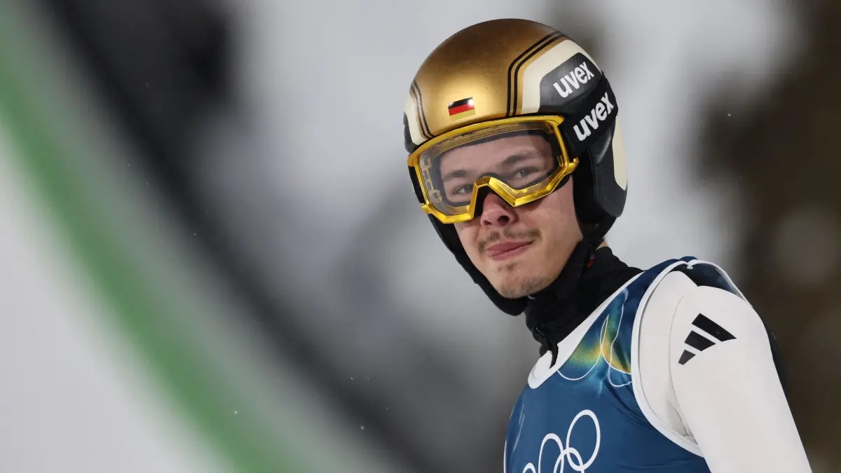 776396159: Germany's Philipp Raimund reacts after jumping during the trial round of the men's large hill individual ski jumping of the Milano Cortina 2026 Winter Olympic Games at Predazzo Ski Jumping Stadium in Predazzo (Val di Fiemme), on February 14, 2026. (Photo by Anne-Christine POUJOULAT / AFP)