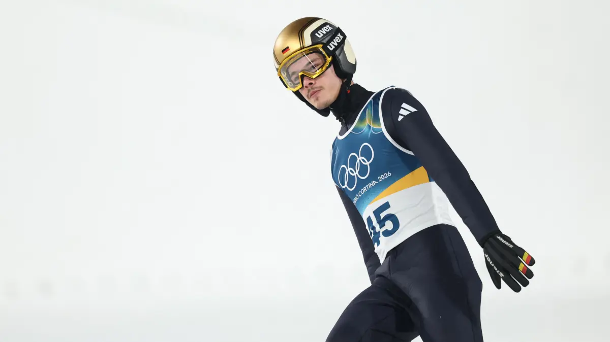 776396159: Germany's Philipp Raimund reacts in the finish area after jumping during the final round of the men's large hill individual ski jumping of the Milano Cortina 2026 Winter Olympic Games at Predazzo Ski Jumping Stadium in Predazzo (Val di Fiemme), on February 14, 2026. (Photo by Anne-Christine POUJOULAT / AFP)