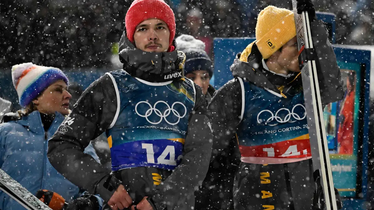 776396161: Germany's Philipp Raimund (L) and Germany's Andreas Wellinger react during the final round of the men's large hill super team ski jumping of the Milano Cortina 2026 Winter Olympic Games at Predazzo Ski Jumping Stadium in Predazzo (Val di Fiemme), on February 16, 2026. (Photo by Tobias SCHWARZ / AFP)