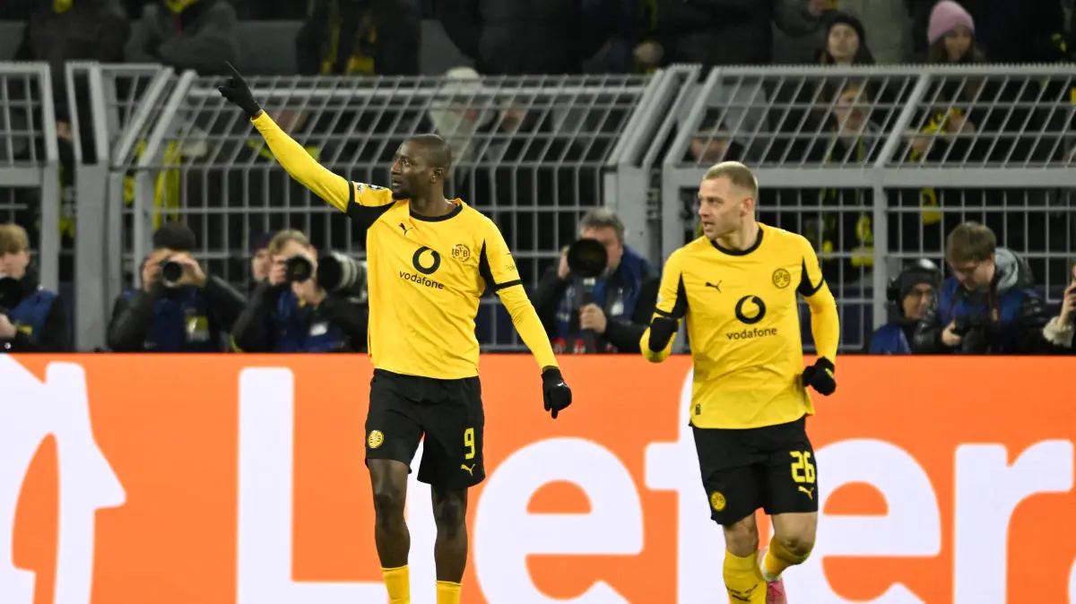 Dortmund's Guinean forward #09 Serhou Guirassy (L) celebrates after scoring his team's first goal during the UEFA Champions League knockout round play-off first Leg football match between BVB Borussia Dortmund and Atalanta Bergamo in Dortmund, western Germany, on February 17, 2026. (Photo by INA FASSBENDER / AFP)