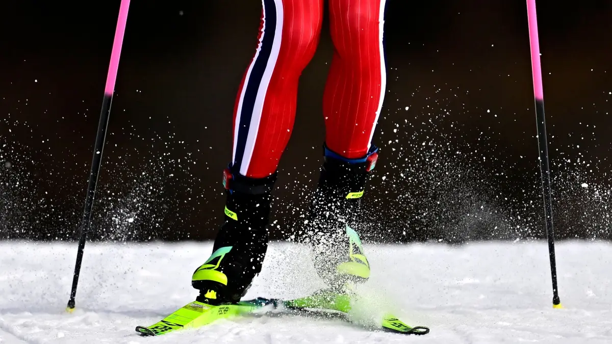 776396186: This photograph shows a view of the knees, legs and feet of Norway's Johannes Hoesflot Klaebo as he skies during the men's team cross country free sprint qualification event of the Milano Cortina 2026 Winter Olympic Games at Tesero Cross-Country Skiing Stadium in Lago di Tesero (Val di Fiemme), on February 18, 2026. (Photo by Tobias SCHWARZ / AFP)
