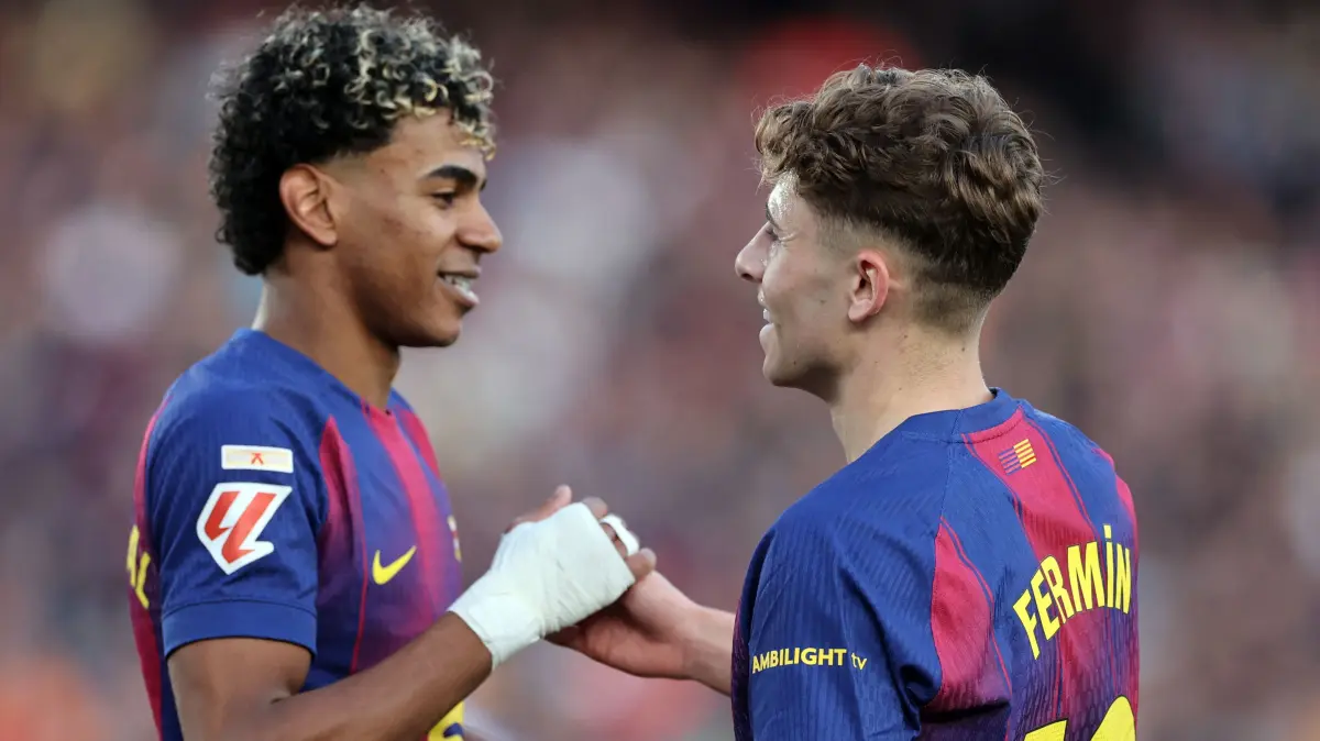 Barcelona's Spanish midfielder #16 Fermin Lopez and Barcelona's Spanish forward #10 Lamine Yamal celebrate their victory at the end of the Spanish league football match between FC Barcelona and Levante UD at Camp Nou Stadium in Barcelona on February 22, 2026. (Photo by Josep LAGO / AFP)