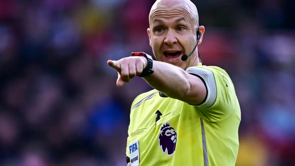 Referee Anthony Taylor gestures during the English Premier League football match between Nottingham Forest and Liverpool at The City Ground in Nottingham, central England on February 22, 2026. (Photo by Ben STANSALL / AFP) / RESTRICTED TO EDITORIAL USE. No use with unauthorized audio, video, data, fixture lists, club/league logos or 'live' services. Online in-match use limited to 120 images. An additional 40 images may be used in extra time. No video emulation. Social media in-match use limited to 120 images. An additional 40 images may be used in extra time. No use in betting publications, games or single club/league/player publications. /
