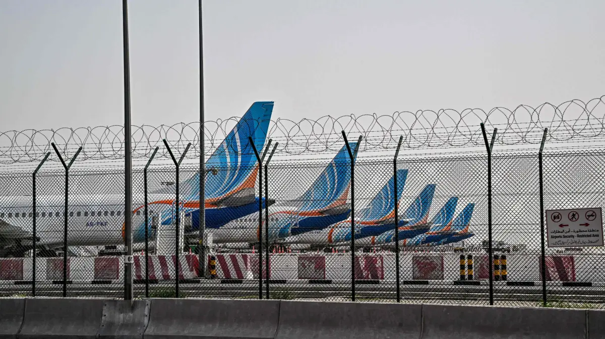 FlyDubai planes are parked on the tarmac at Dubai International Airport as Iran retaliates following the US and Israel’s assassination of its supreme leader, in Dubai on March 2, 2026. The United States hit hundreds of targets across Iran, and Israel expanded its bombing to Lebanon on March 2 as US President Donald Trump vowed to avenge the first US deaths in the war he launched to topple Tehran's ruling clerics. Iranian forces fired missiles and drones across the Middle East, killing people in Israel and the United Arab Emirates, in retaliation for the conflict that began Saturday with the death of Iran's supreme leader, Ayatollah Ali Khamenei. (Photo by Giuseppe CACACE / AFP)