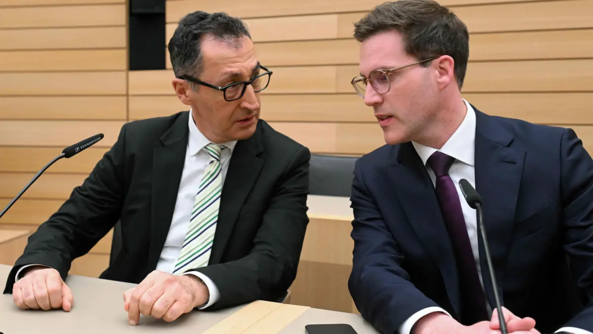 Cem Ozdemir (L), top candidate of the Greens, and
Manuel Hagel, top candidate of Christian Democratic Union (CDU)
attend a press conference at the regional parliament after exit polls were announced in the state elections on March 8, 2026 in Stuttgart, southern Germany.. The German Greens have beaten Chancellor Friedrich Merz's conservative CDU in a state election seen as a test for the German leader, according to exit polls. (Photo by THOMAS KIENZLE / AFP)