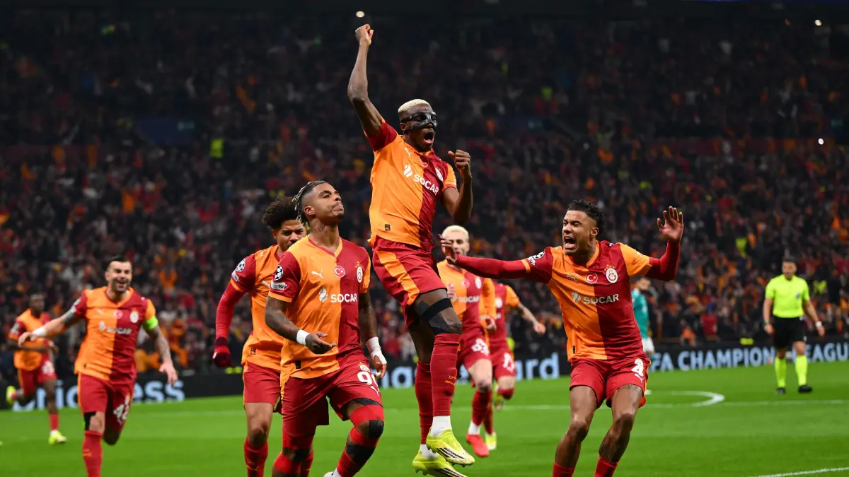 Galatasaray's Gabonese midfielder #99 Mario Lemina (L) celebrates with Galatasaray's Nigerian forward #45 Victor Osimhen (C) and Galatasaray's Senegalese defender #04 Ismail Jakobs after scoring the opening goal during the UEFA Champions League round of 16 first leg football match between Galatasaray SK and Liverpool FC at the Ali Sami Yen Sports Complex in Istanbul on March 10, 2026. (Photo by YASIN AKGUL / AFP)
