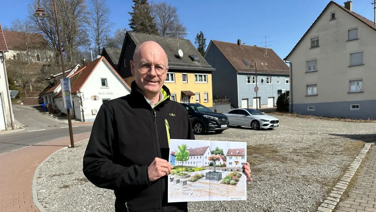 Bürgermeister Stefan Weiskopf hält den Entwurf in Händen: So könnte es bald schon in Hausens Dorfmitte aussehen.