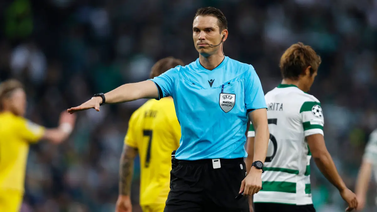 Swiss referee Sandro Scharer gestures during the UEFA Champions League last 16 second leg football match between Sporting CP and Bodoe/Glimt at Jose Alvalade stadium in Lisbon on March 17, 2026. (Photo by FILIPE AMORIM / AFP)