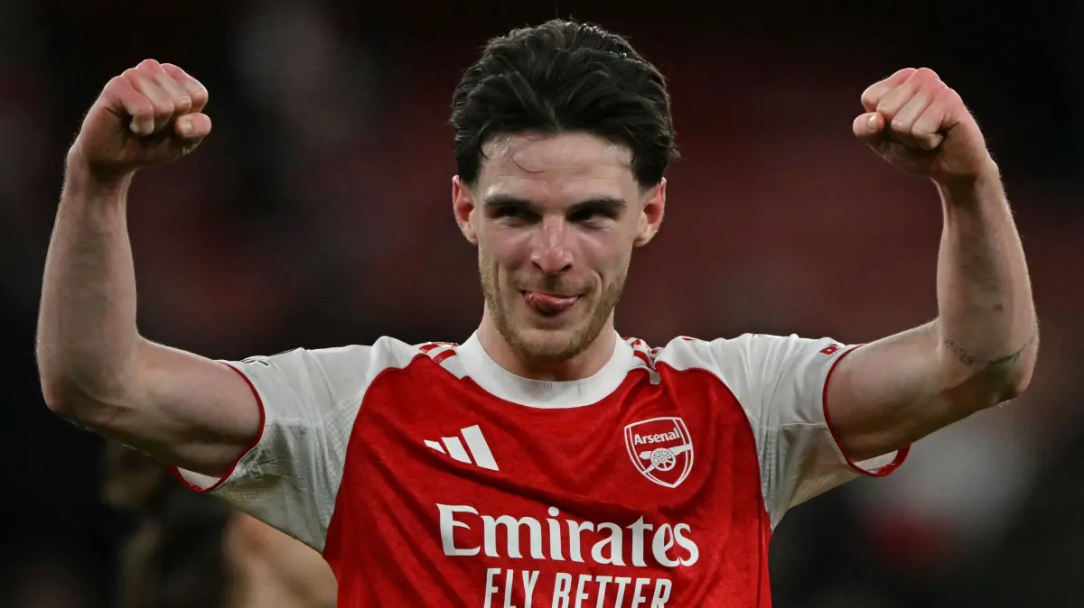 Arsenal's English midfielder #41 Declan Rice (L) celebrates at the final whistle during the UEFA Champions League, last 16 second leg football match between Arsenal and Bayer Leverkusen at the Emirates Stadium in north London on March 17, 2026. Arsenal won the match 2-1. (Photo by Glyn KIRK / AFP)