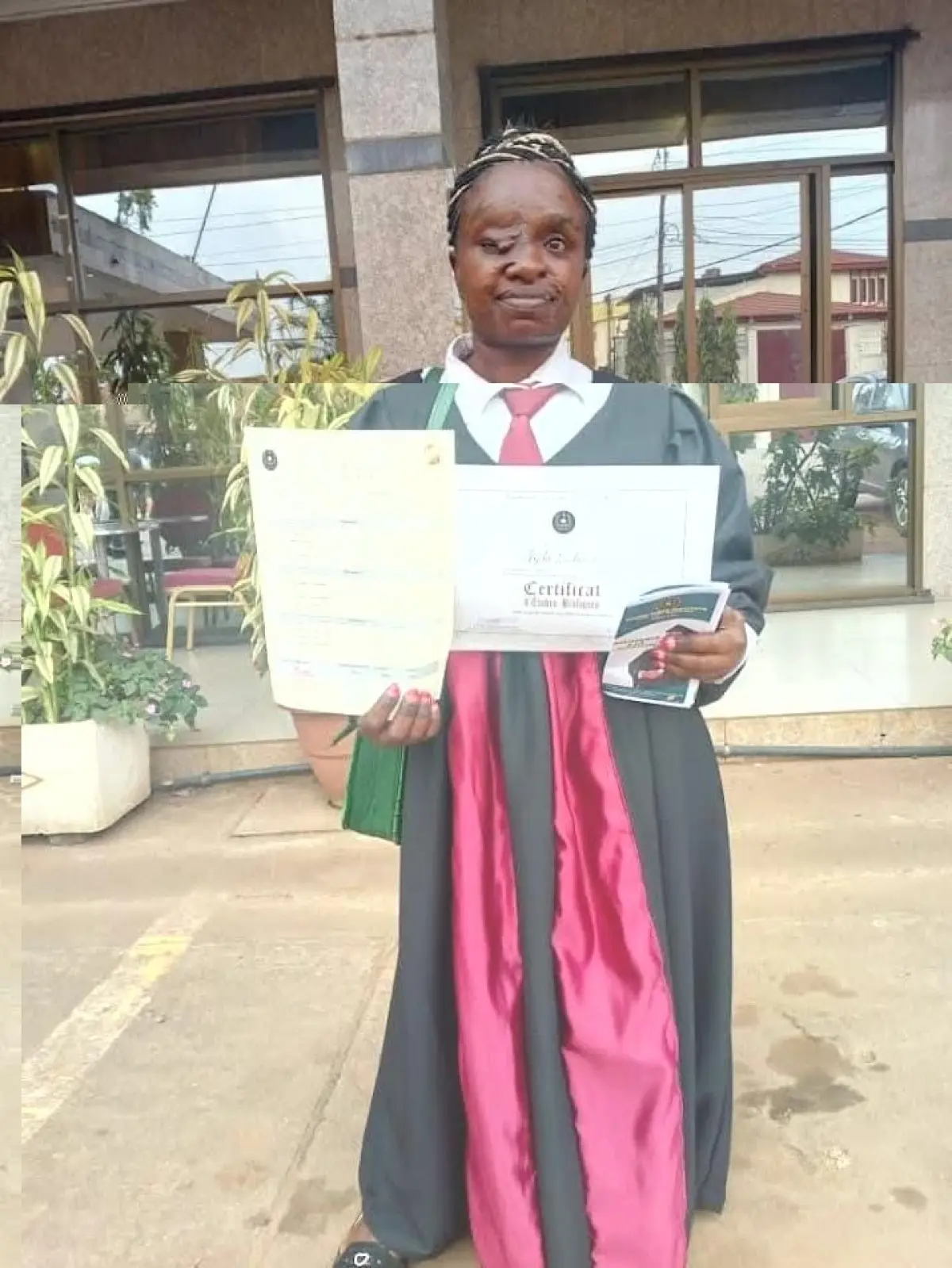 Stolz präsentiert Ladouce, die unter einem Tumor im Gesicht leidet, ihre Diplome. Der Verein „Roots of Hope“ will der jungen Frau eine Operation ermöglichen.