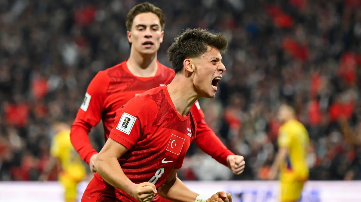 Turkey's midfielder #08 Arda Guler (R) celebrates after his team scored during the play-off FIFA World Cup 2026 European qualification knockout semi-final football match between Turkey and Romania at Besiktas Park stadium, in Istanbul on March 26, 2026. (Photo by YASIN AKGUL / AFP)
