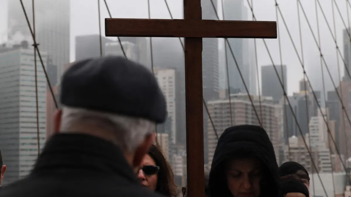 Catholics Hold Way Of Cross Processions In New York On Good Friday: NEW YORK, NEW YORK - APRIL 03: Worshippers walk to a station during the Way of the Cross procession over the Brooklyn Bridge on April 03, 2026 in New York City. The Way of the Cross is a traditional Catholic procession recalling the suffering and death of Jesus Christ and often includes Gospel readings, choral music, and readings at stations along the way. This anniversary procession across the iconic bridge has been a tradition for decades. Spencer Platt/Getty Images/AFP (Photo by SPENCER PLATT / GETTY IMAGES NORTH AMERICA / Getty Images via AFP)
