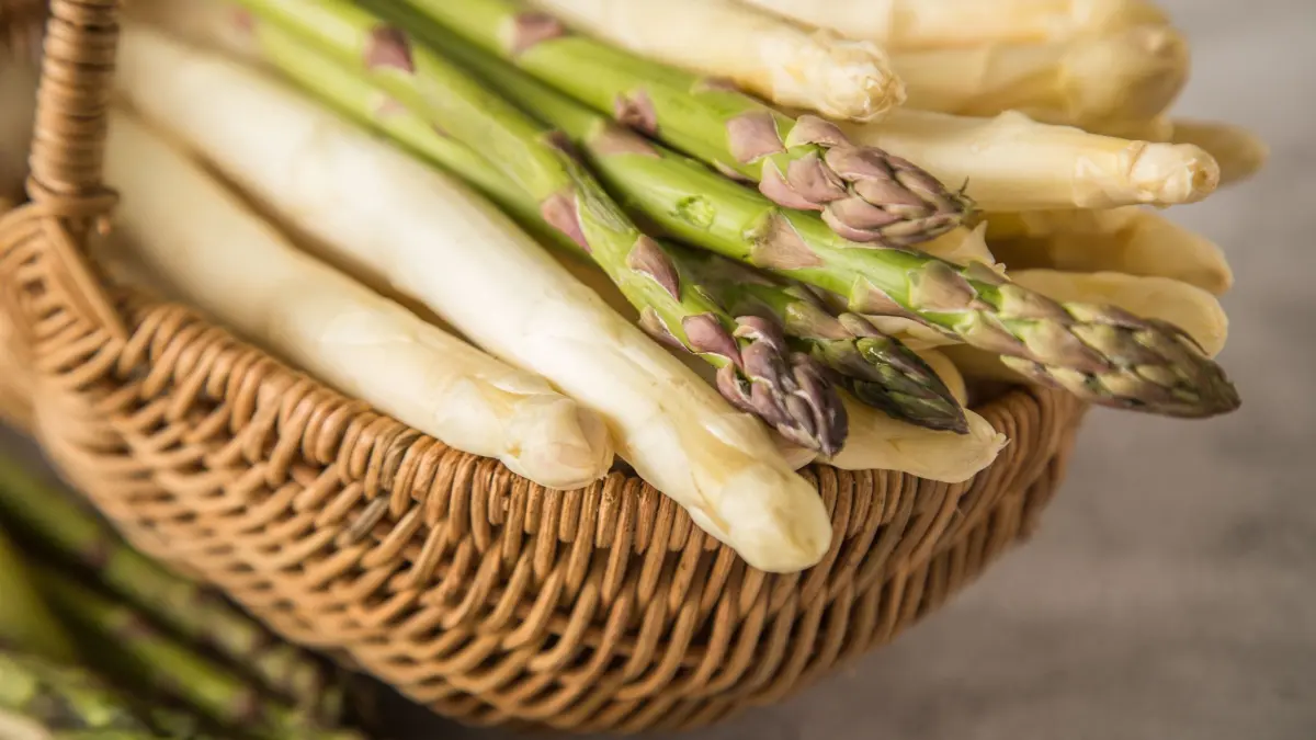 Weißer und grüner Spargel liegen in einem Korb
