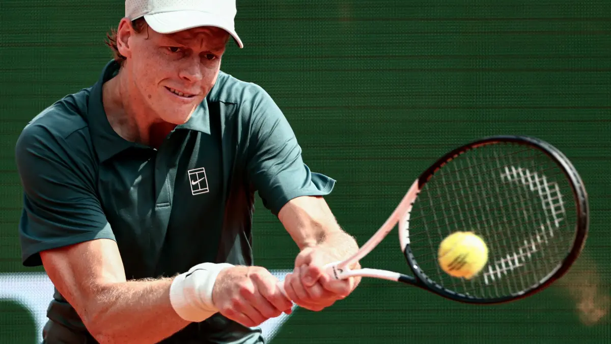 Italy's Jannik Sinner plays a backhand return to Germany's Alexander Zverev during the Monte Carlo ATP Masters Series Tournament semi-final tennis match on Court Rainier III at the Monte-Carlo Country Club in Roquebrune-Cap-Martin, south-eastern France on April 11, 2026. (Photo by Thibaud MORITZ / AFP)