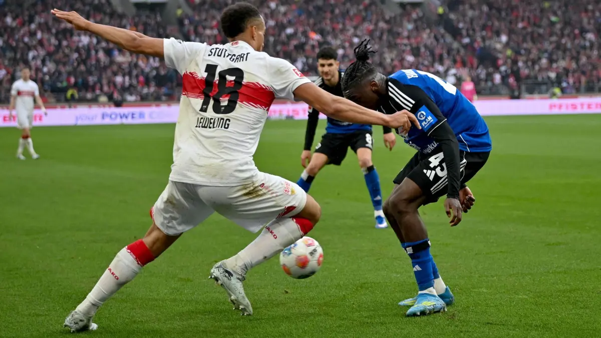 VfB Stuttgart - Hamburger SV: 12.04.2026, Baden-Württemberg, Stuttgart: Fußball, Männer: Bundesliga, VfB Stuttgart - Hamburger SV, 29. Spieltag, MHPArena. Jamie Leweling (VfB Stuttgart, l) und Fabio Baldé (Hamburger SV) in Aktion. Foto: Katharina Kausche/dpa - WICHTIGER HINWEIS: Gemäß den Vorgaben der DFL Deutsche Fußball Liga bzw. des DFB Deutscher Fußball-Bund ist es untersagt, in dem Stadion und/oder vom Spiel angefertigte Fotoaufnahmen in Form von Sequenzbildern und/oder videoähnlichen Fotostrecken zu verwerten bzw. verwerten zu lassen. +++ dpa-Bildfunk +++