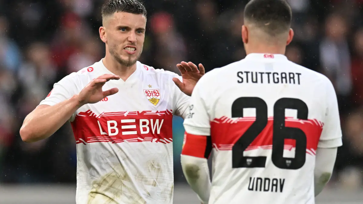 Stuttgart's Bosnian forward #09 Ermedin Demirovic (L) reacts with Stuttgart's German forward #26 Deniz Undav after scoring a goal that was disallowed during the German first division Bundesliga football match between VfB Stuttgart and Hamburger SV in Stuttgart, southwestern Germany on April 12, 2026. (Photo by THOMAS KIENZLE / AFP) / DFL REGULATIONS PROHIBIT ANY USE OF PHOTOGRAPHS AS IMAGE SEQUENCES AND/OR QUASI-VIDEO