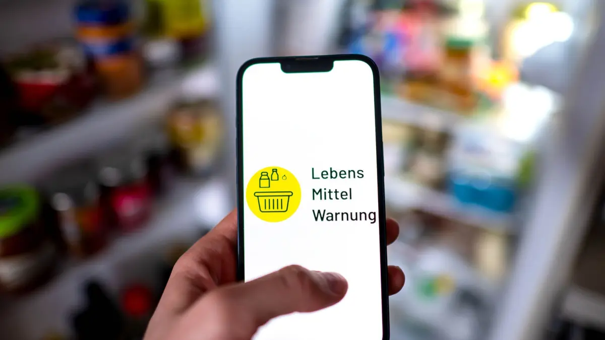 Lebensmittelwarnung: ILLUSTRATION - 17.03.2026, Bremen: Die App «Lebensmittelwarnung» ist auf einem Smartphone vor einem geöffneten Kühlschrank zu sehen. (zu dpa: «Mögliche Gesundheitsgefährdung: Rückruf von Instant-Nudeln») Foto: Sina Schuldt/dpa +++ dpa-Bildfunk +++