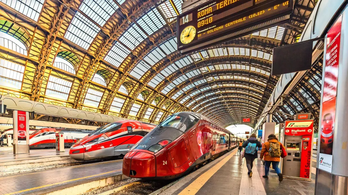 MILANO, ITALY - DECEMBER 12, 2018: TRENITALIA FRECCIAROSSA and NTV ITALO trains waiting at Milano Centrale station xkwx Italo, Italy, NTV, arriving, centrale, commuters, editorial, frecciarossa, leaving, milano, standing, station, tourism, tourists, train, trains, travellers, trenitalia, waiting