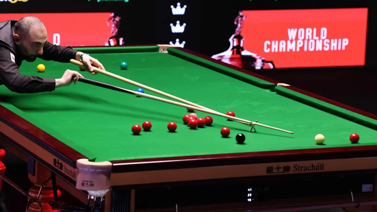 776479936: Iran's Hossein Vafaei plays a shot against China's Si Jiahui during the World Snooker Championship Round One match at The Crucible in Sheffield, northern England on April 22, 2026. The World Snooker Championship 2025 will take place from April 19 to May 5, 2025. (Photo by Darren Staples / AFP)