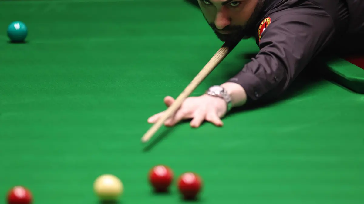 776479936: Iran's Hossein Vafaei plays a shot against opponent China's Si Jiahui (not pictured) during their World Snooker Championship Round One match at The Crucible in Sheffield, northern England on April 22, 2026. The World Snooker Championship 2025 will take place from April 19 to May 5, 2025. (Photo by Darren Staples / AFP)