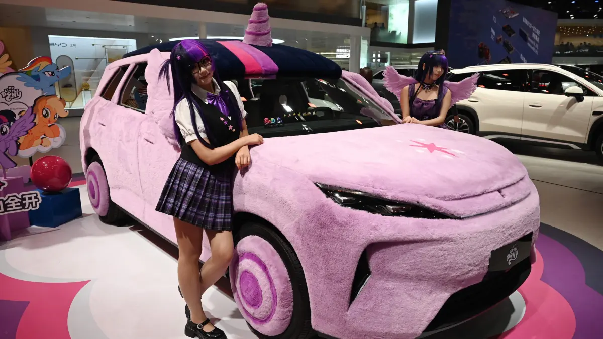 A car lined with plush material is displayed on the BYD stand at the Beijing Auto Show in Beijing on April 25, 2026. (Photo by GREG BAKER / AFP)