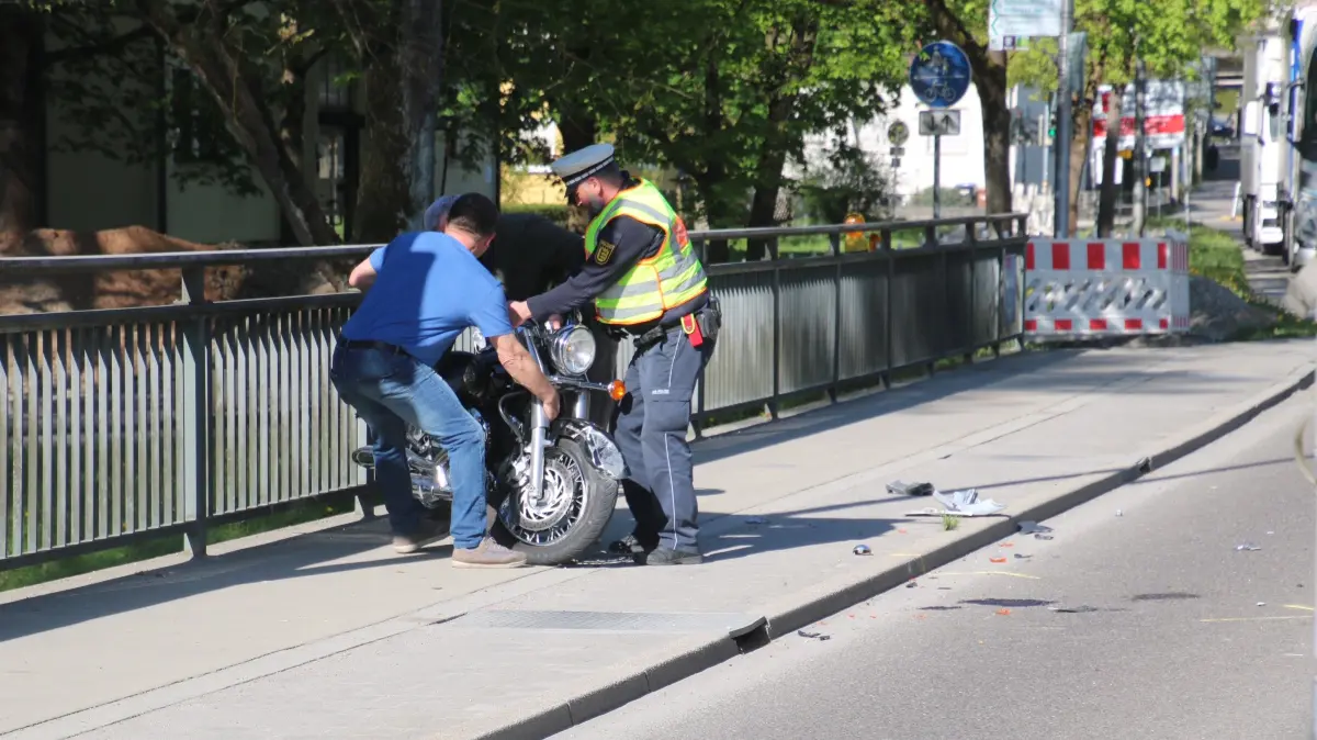 Zu dritt wird die schwere Maschine von der Fahrbahn auf den Gehweg neben der Goethestraße gepackt.