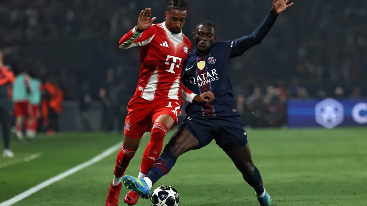 Bayern Munich's French midfielder #17 Michael Olise fights for the ball with Paris Saint-Germain's Portuguese defender #25 Nuno Mendes during the UEFA Champions League semi-final first leg football match between Paris Saint-Germain (PSG) and Bayern Munich at the Parc des Princes in Paris on April 28, 2026. (Photo by Anne-Christine POUJOULAT / AFP)