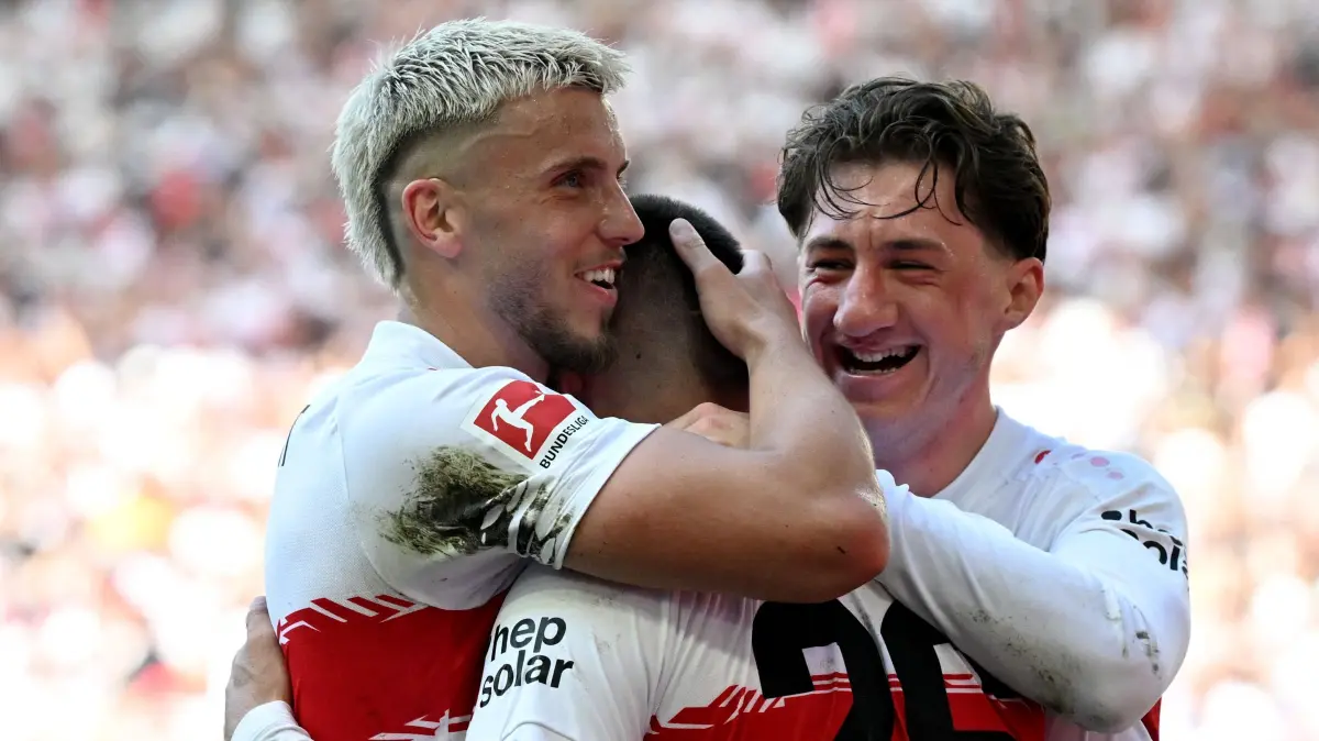 Stuttgart's German forward #26 Deniz Undav (C) celebrates with Stuttgart's Bosnian forward #09 Ermedin Demirovic (L) and Stuttgart's German midfielder #06 Angelo Stiller (R) after scoring the 3-1 goal during the German first division Bundesliga football match between VfB Stuttgart and Bayer 04 Leverkusen in Stuttgart, southwestern Germany on May 9, 2026. (Photo by THOMAS KIENZLE / AFP) / DFL REGULATIONS PROHIBIT ANY USE OF PHOTOGRAPHS AS IMAGE SEQUENCES AND/OR QUASI-VIDEO
