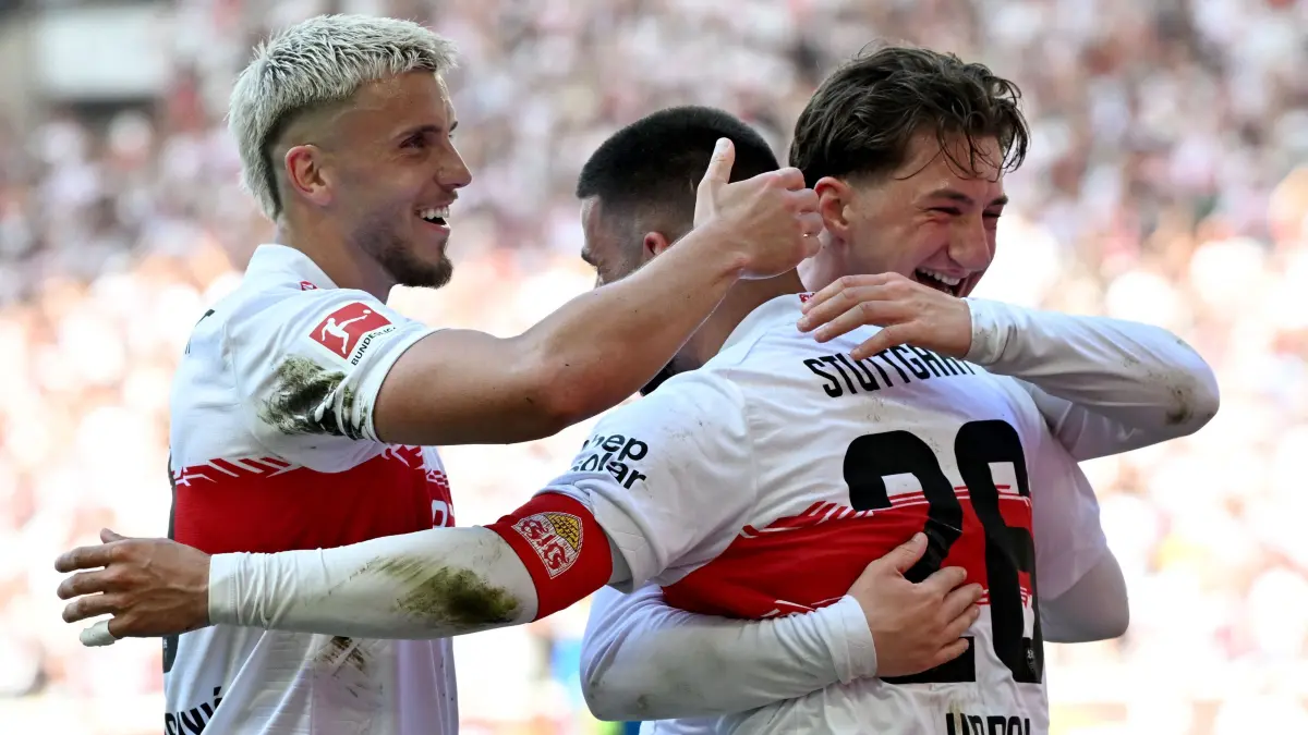 Stuttgart's German forward #26 Deniz Undav (C) celebrates with Stuttgart's Bosnian forward #09 Ermedin Demirovic (L) and Stuttgart's German midfielder #06 Angelo Stiller (R) after scoring the 3-1 goal during the German first division Bundesliga football match between VfB Stuttgart and Bayer 04 Leverkusen in Stuttgart, southwestern Germany on May 9, 2026. (Photo by THOMAS KIENZLE / AFP) / DFL REGULATIONS PROHIBIT ANY USE OF PHOTOGRAPHS AS IMAGE SEQUENCES AND/OR QUASI-VIDEO