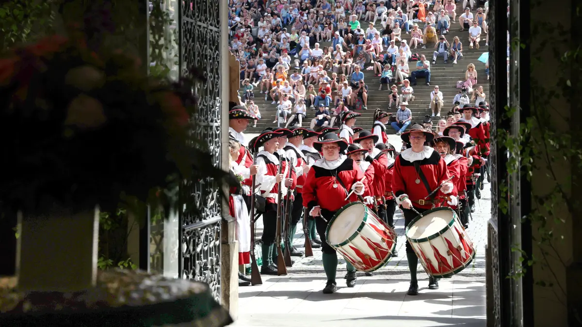 Die Trommler des Großen Siedershof marschieren ins Schwäbisch Haller Rathaus. Dort wartet der Siederskuchen, der gleich den Zuschauern auf der Großen Treppe präsentiert wird. Viele Hunderte verfolgen den Programmpunkt des Kuchen- und Brunnenfests am Sonntag.