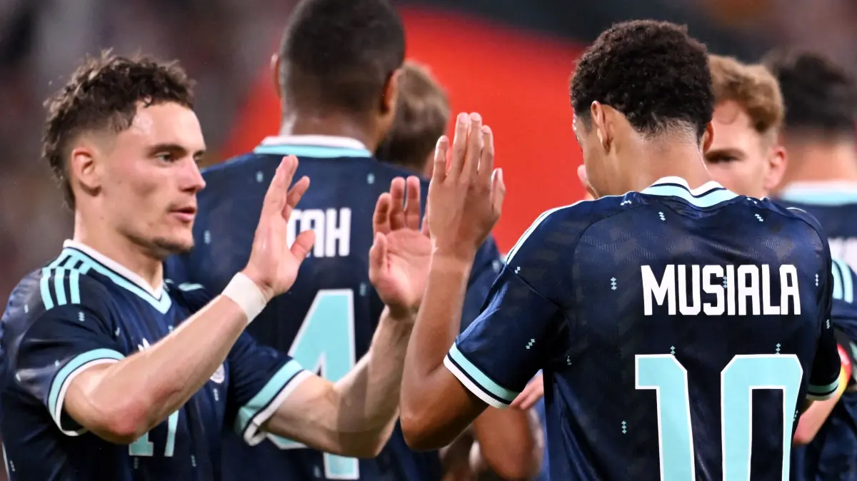 Germany's midfielder #10 Jamal Musiala (R) celebrates scoring his team's fourth goal with teammate Germany's midfielder #17 Florian Wirtz and others during a friendly match between Germany and Finland ahead of the 2026 FIFA World Cup football tournament, in Mainz, western Germany on May 31, 2026. (Photo by Kirill KUDRYAVTSEV / AFP)