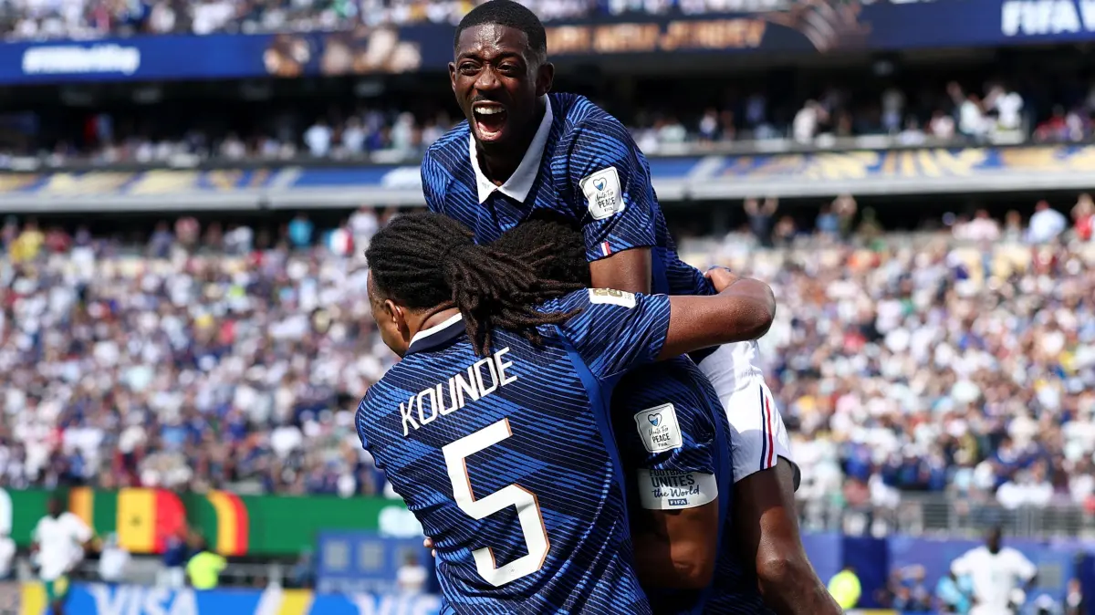 FBL-WC-2026-MATCH17-FRA-SEN: France's forward #10 Kylian Mbappe celebrates with teammates defender #05 Jules Kounde and forward #07 Ousmane Dembele (top) after scoring his team's first goal during the 2026 World Cup Group I football match between France and Senegal at the New York/New Jersey Stadium in East Rutherford on June 16, 2026. (Photo by CHARLY TRIBALLEAU / AFP)