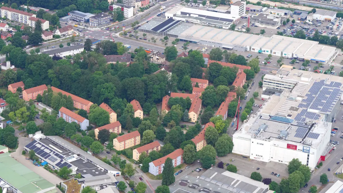 Hier spielt in den kommenden Jahren die Musik in Neu-Ulm. Das Luftbild zeigt die Elefantensiedlung mit rechts dem weitgehend leerstehenden Ex-Möbel-Mutschler-Möbelhaus sowie im oberen Teil der Aufnahme das ebenfalls größtenteils leerstehende Fachmarktzentrum (Baywa-Baumarkt).