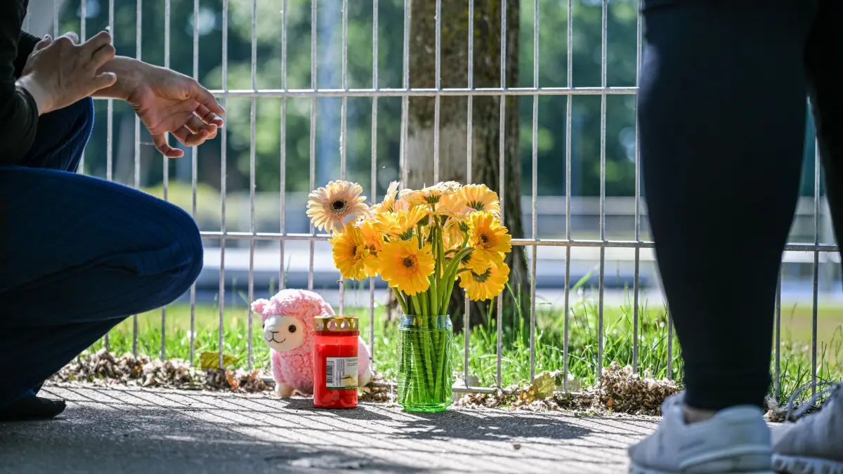 Nach dem Fund von leblosem Kind in Auto: 18.06.2026, Baden-Württemberg, Schorndorf: Eine Frau legt Blumen nieder, nachdem ein lebloses Kind in einem Auto gefunden wurde, Foto: Jason Tschepljakow/dpa +++ dpa-Bildfunk +++