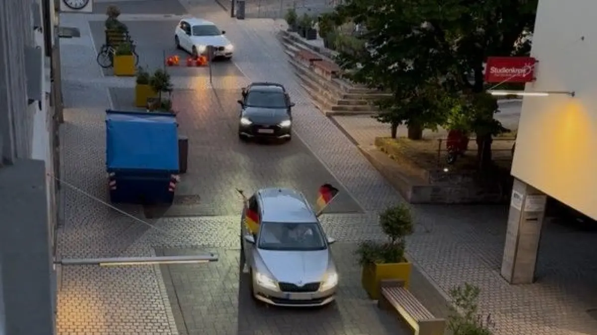 Ein Autokorso fährt die gesperrte Marktstraße in der Haller Innenstadt hinunter.
