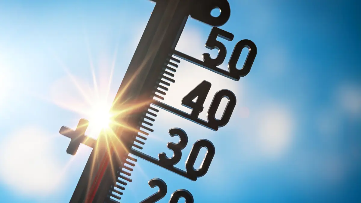 Hitzewelle über Deutschland - Symbolbild: Thermometer vor gleißender Sonne, Symbolfoto Hitzewelle, Fotomontage +++ nur redaktionelle Nutzung