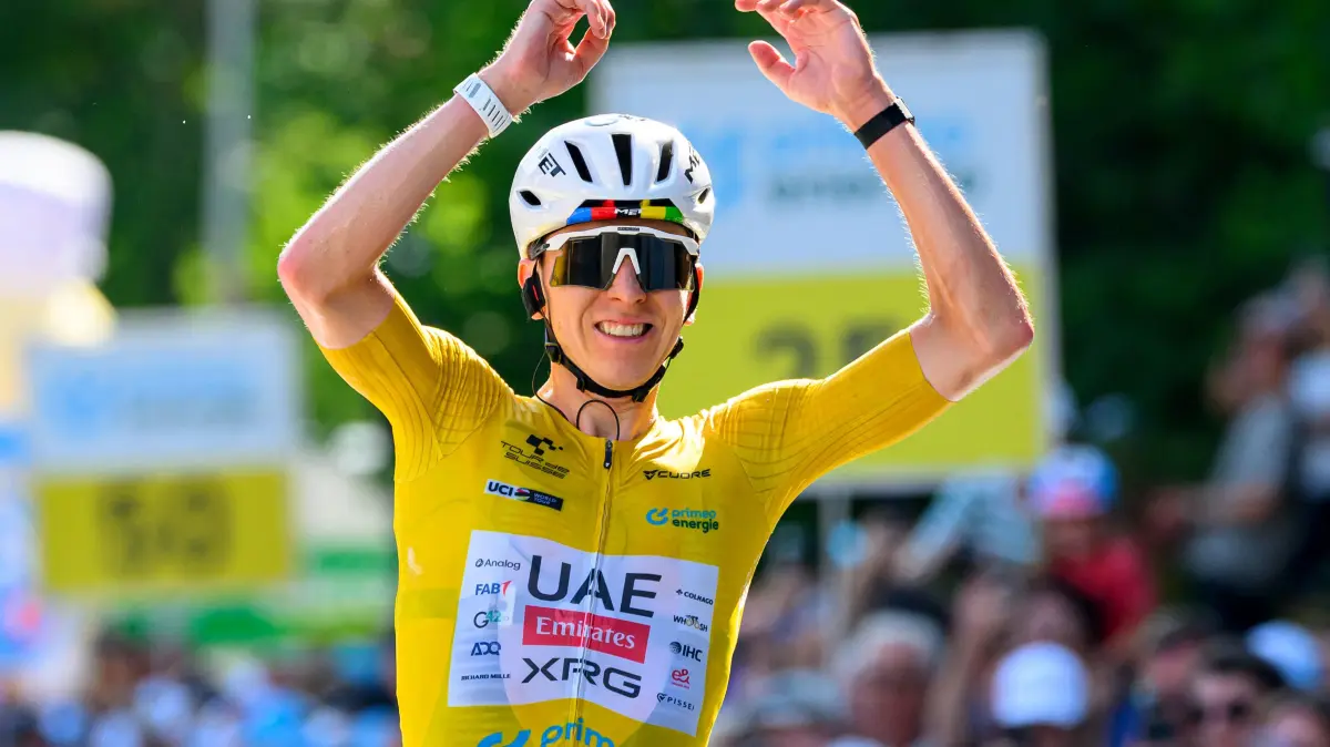 CYCLING-SUI-TOUR-MEN: UAE Team Emirates - XRG team's Slovenian rider Tadej Pogacar celebrates as he crosses the finish line to win the fith and final stage of the Men's Tour of Switzerland (Tour de Suisse) cycling race, 150.7 km starting and finishing in Villars-sur-Ollon on June 21, 2026. (Photo by Harold Cunningham / AFP)