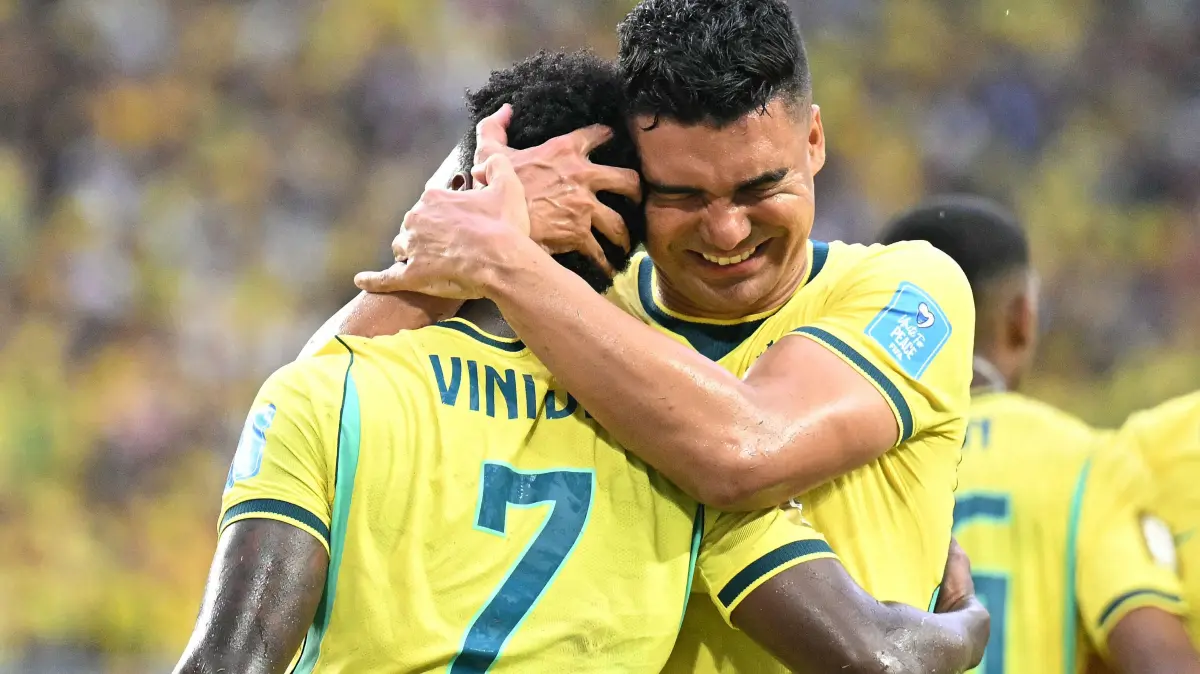 FBL-WC-2026-MATCH49-SCO-BRA: Brazil's forward #07 Vinicius Junior celebrates with teammate Brazil's midfielder #05 Casemiro scoring his team's second goal during the 2026 World Cup Group C football match between Scotland and Brazil at the Miami Stadium in Miami Gardens on June 24, 2026. (Photo by CHANDAN KHANNA / AFP)